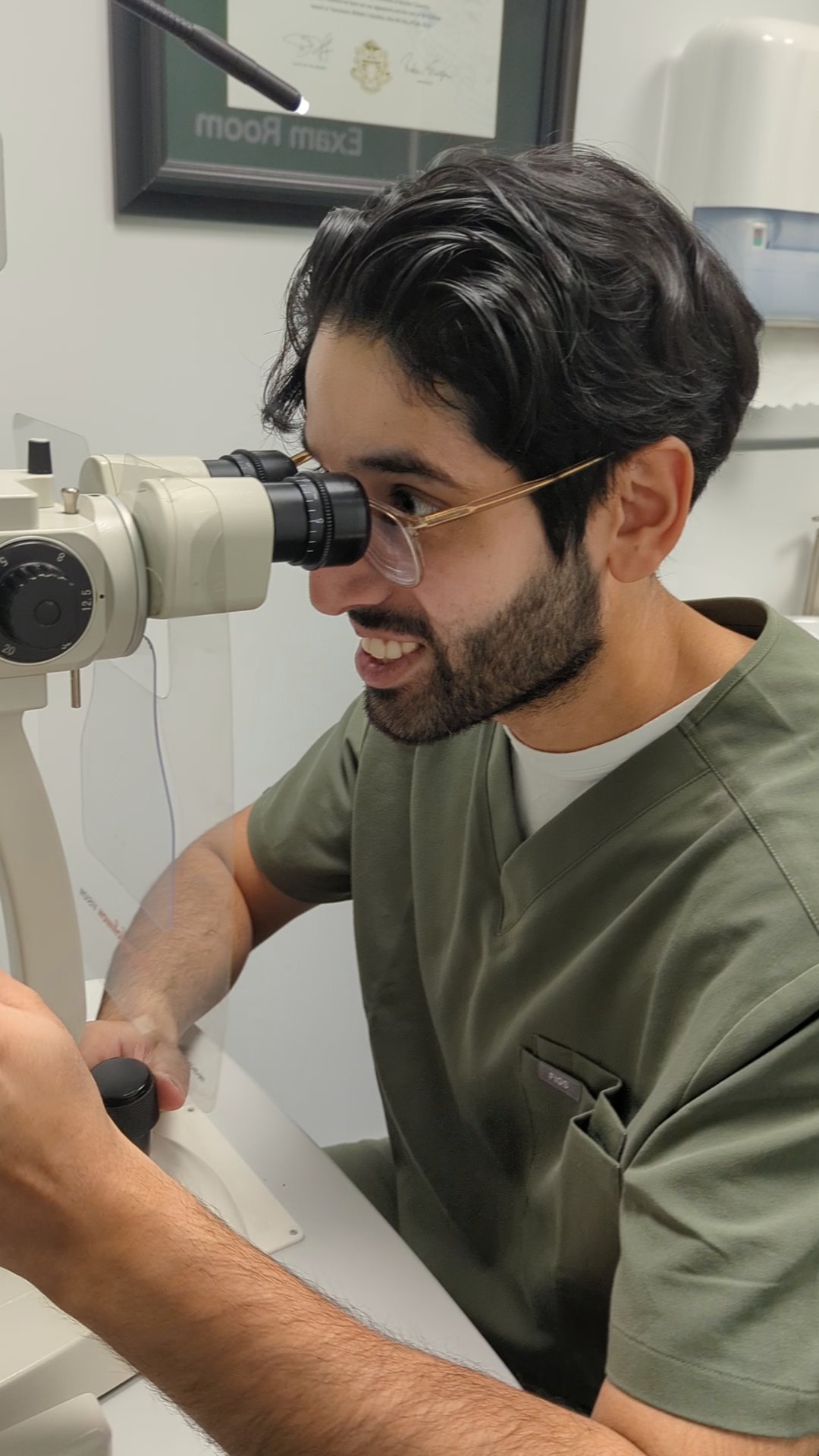 Dr. Munraj Bajwa examining a patient at the slit lamp