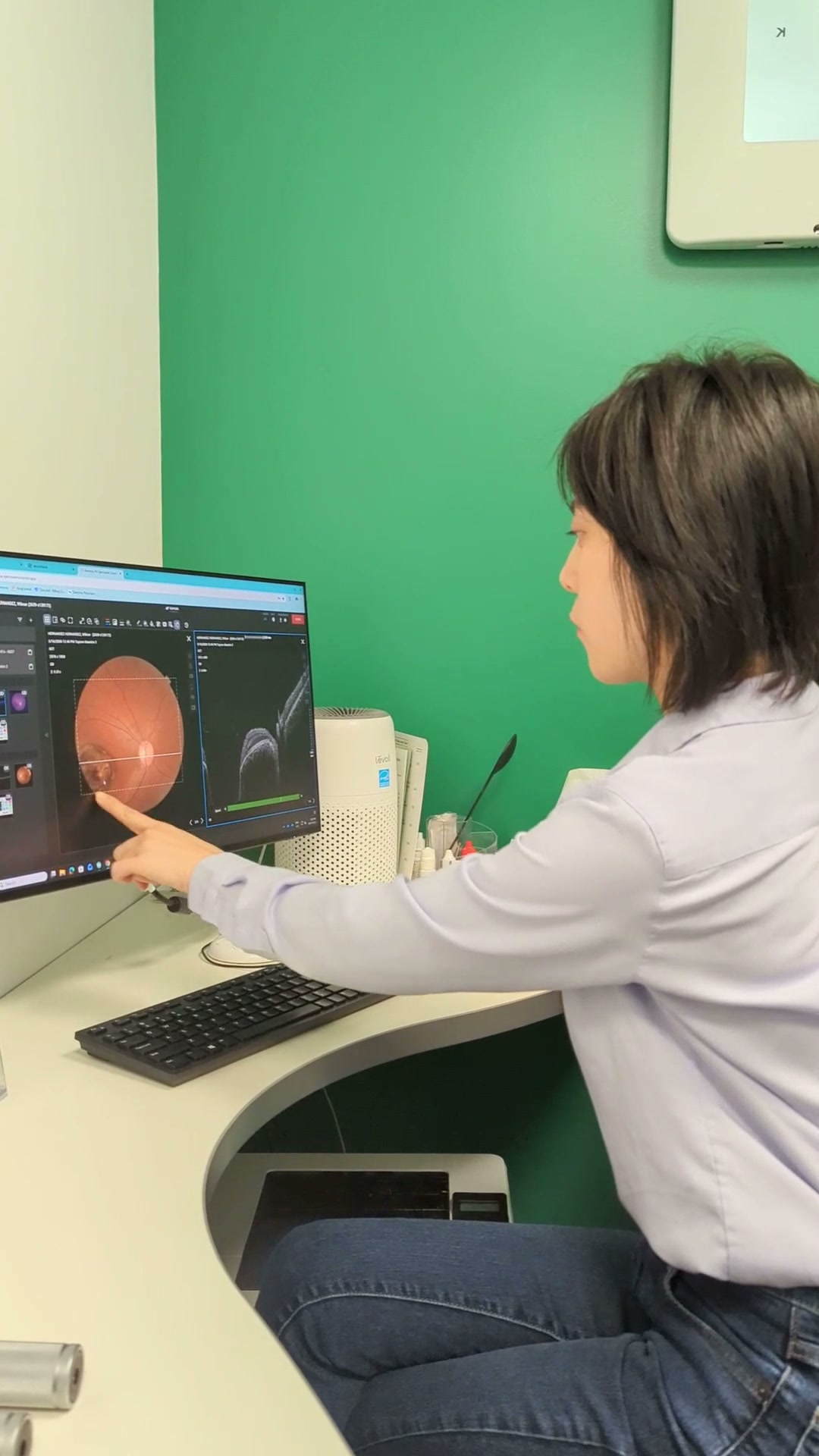 Dr. Laura Lin reviewing an OCT retinal scan at Guildford Eye Clinic