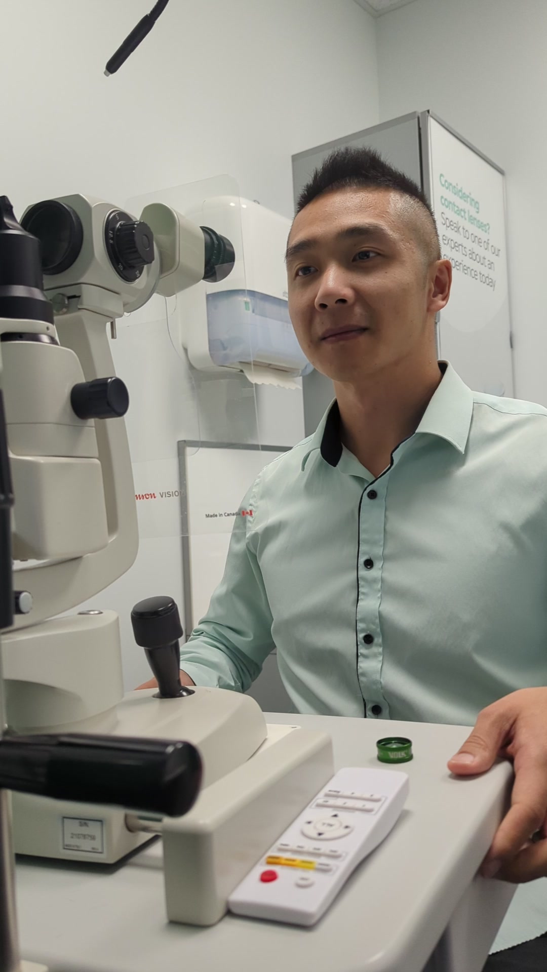 Dr. Phil Xue examining a patient at the slit lamp