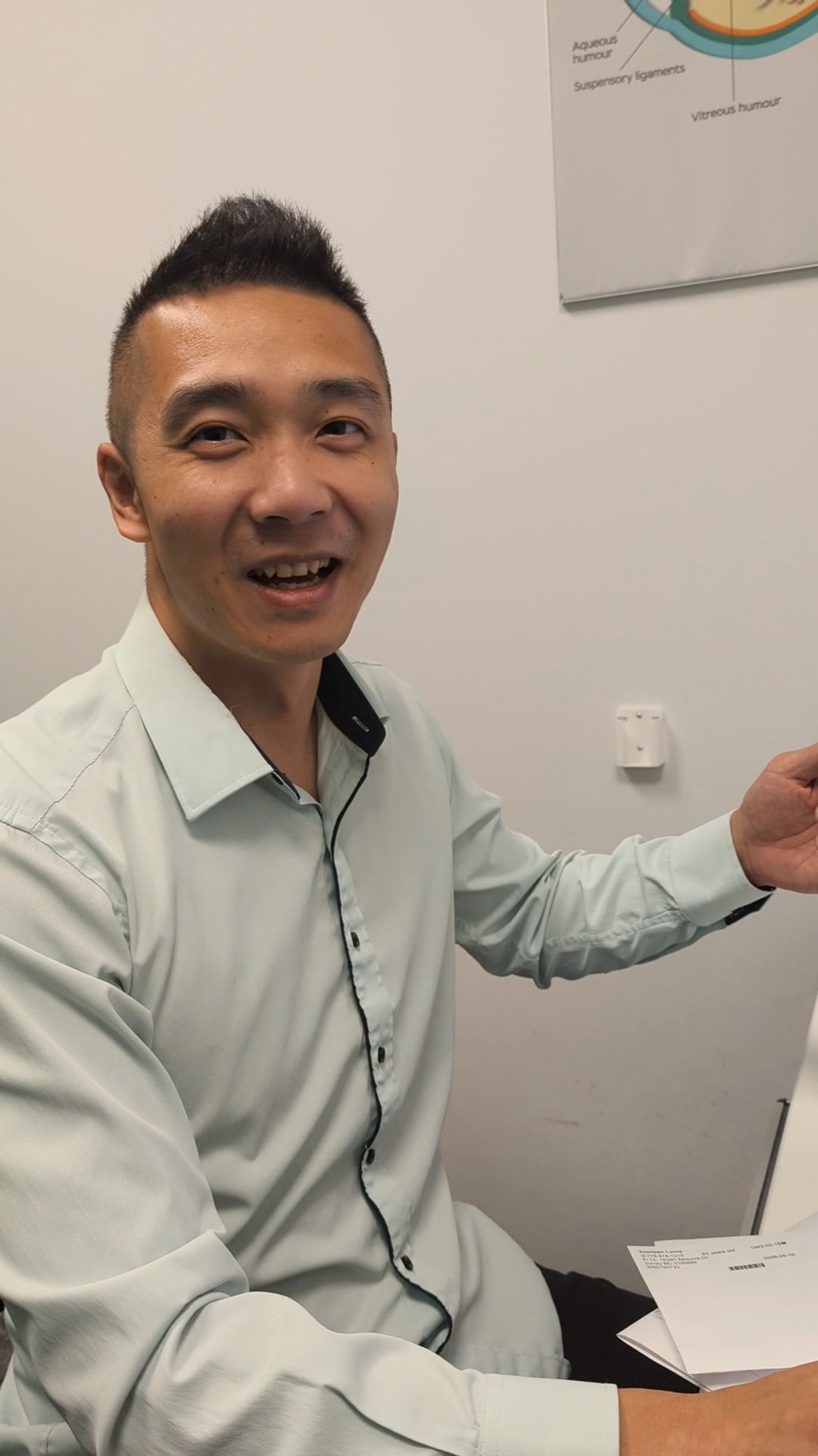 Dr. Phil Xue reviewing an OCT retinal scan with a patient